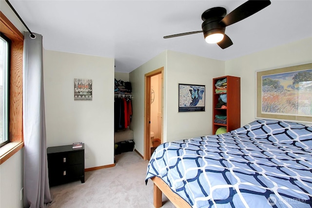 bedroom featuring light carpet, a ceiling fan, and baseboards