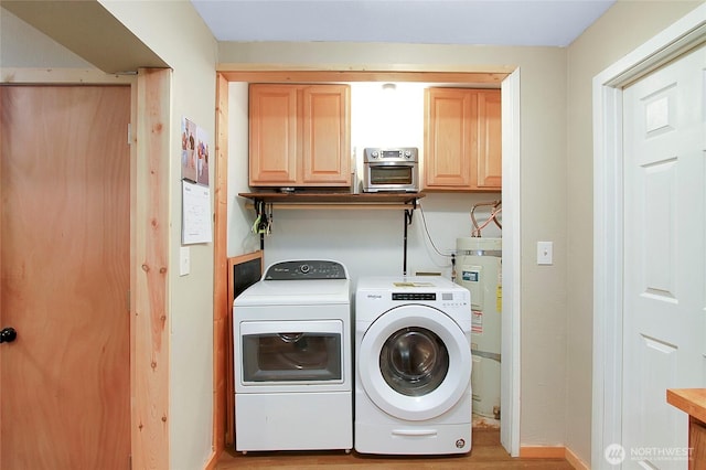 laundry area with washer and clothes dryer, cabinet space, light wood finished floors, baseboards, and secured water heater