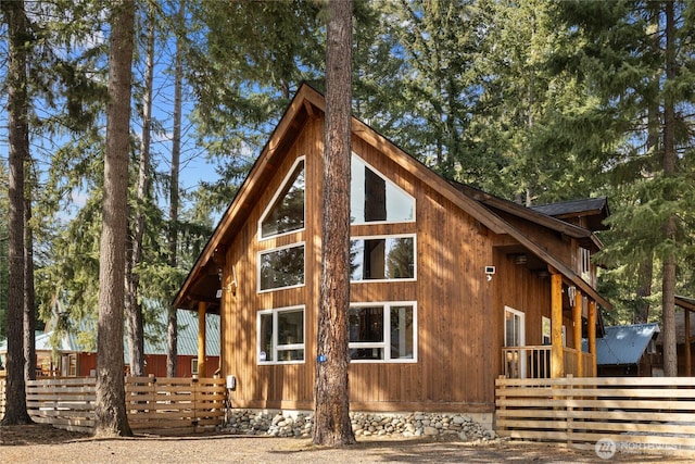 view of side of home featuring fence