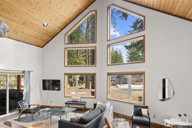 living room with wooden ceiling, high vaulted ceiling, baseboards, and wood finished floors