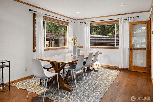 dining space with hardwood / wood-style flooring, plenty of natural light, and baseboards