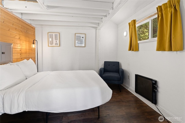 bedroom with beam ceiling, electric panel, wood finished floors, wood walls, and baseboards