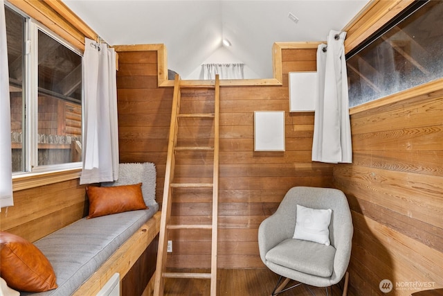 sitting room featuring wood walls