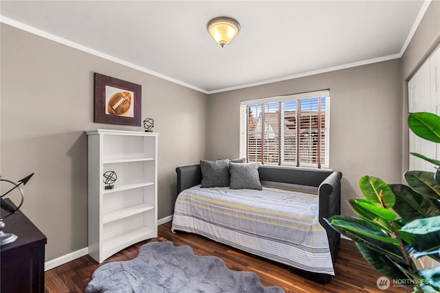 bedroom with baseboards, wood finished floors, and crown molding