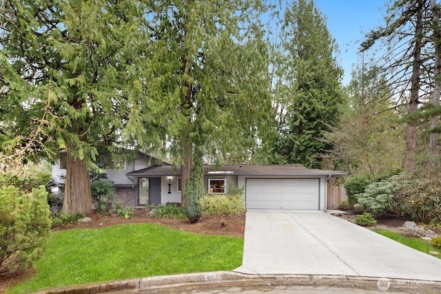 view of front of home featuring a garage, concrete driveway, and a front yard