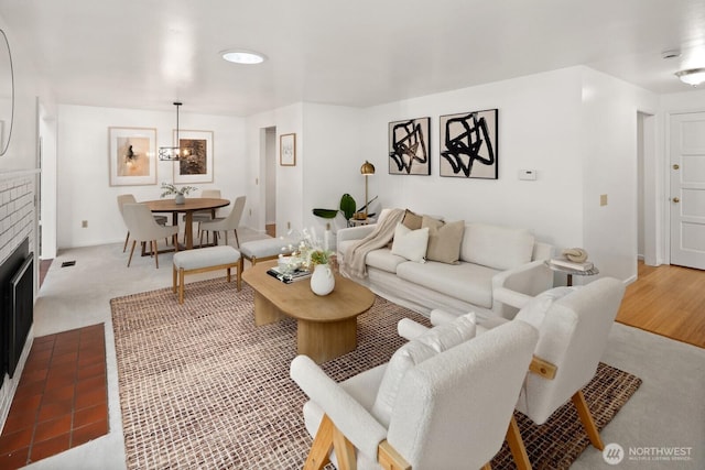 living area featuring visible vents and a brick fireplace