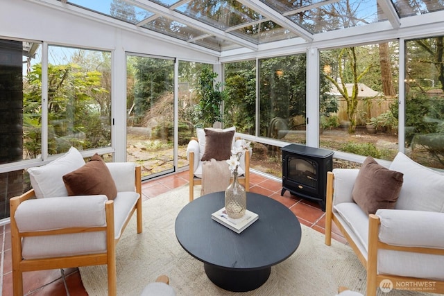 sunroom featuring a skylight and a wood stove