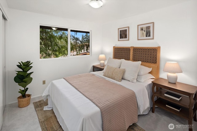 bedroom with baseboards and carpet floors