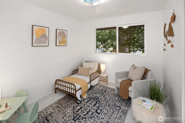 living area with baseboards and carpet