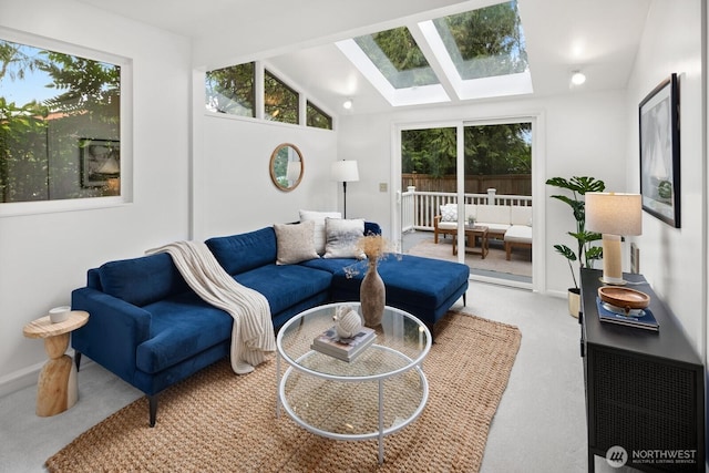 sunroom / solarium with vaulted ceiling with skylight