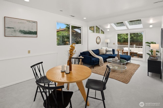 carpeted dining area featuring recessed lighting, visible vents, and a wealth of natural light