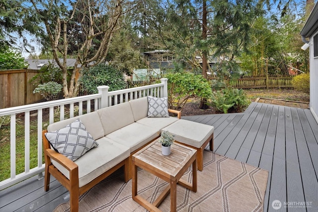 deck with an outdoor living space and a fenced backyard