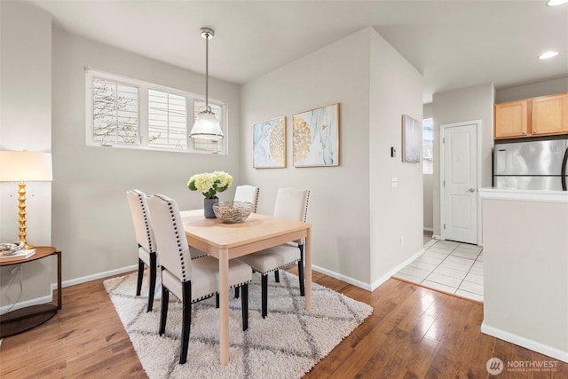 dining space featuring recessed lighting, light wood-type flooring, and baseboards