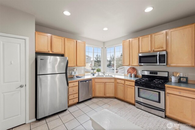 kitchen featuring light brown cabinets, a sink, recessed lighting, appliances with stainless steel finishes, and light tile patterned floors