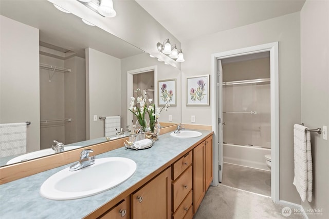 full bathroom featuring double vanity, toilet, and a sink