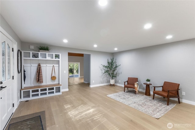 sitting room with light wood-style flooring, recessed lighting, and baseboards