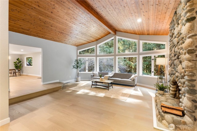 unfurnished living room with wood finished floors, baseboards, high vaulted ceiling, wooden ceiling, and beamed ceiling