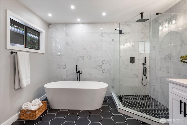 bathroom featuring recessed lighting, a soaking tub, tile walls, and a shower stall