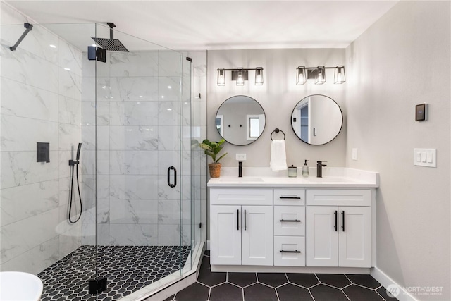 full bathroom with a sink, a stall shower, double vanity, and tile patterned flooring