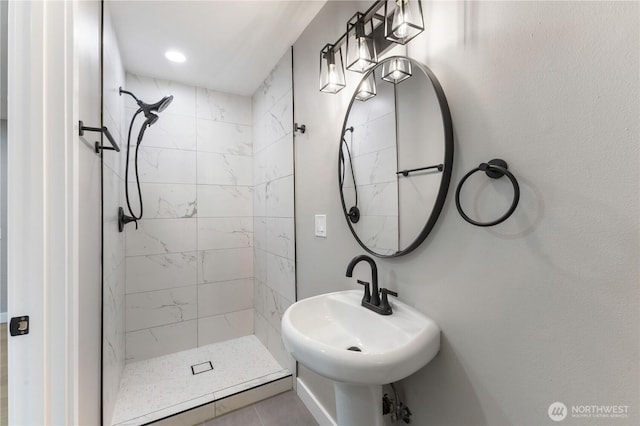 full bathroom featuring a shower stall and a sink