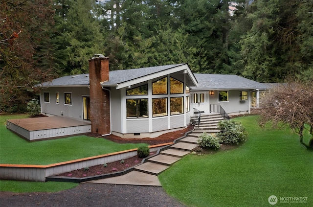 view of front of home with crawl space, a chimney, a front lawn, and roof with shingles