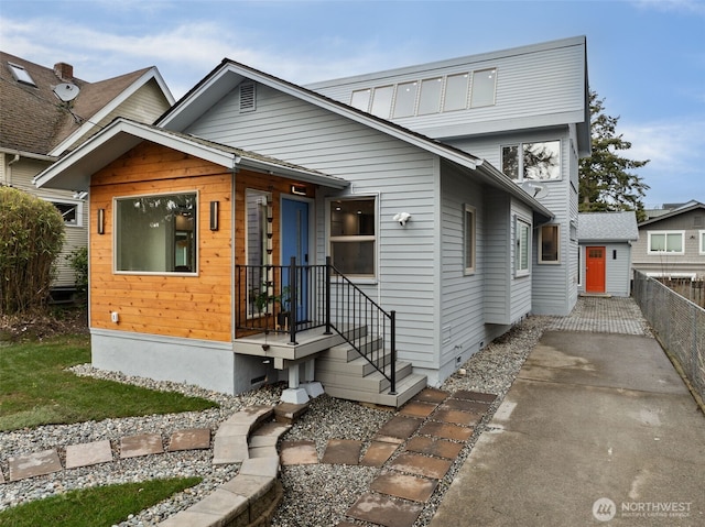 view of front of home featuring fence