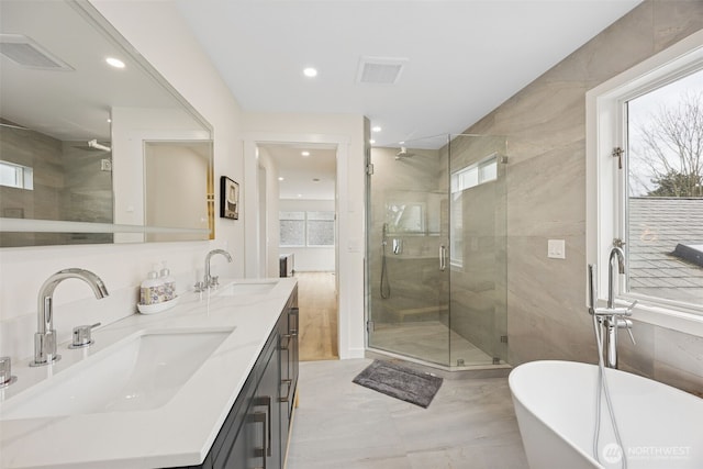 bathroom featuring visible vents, a wealth of natural light, and a sink