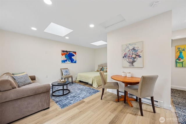 bedroom with recessed lighting, light wood-style floors, and baseboards