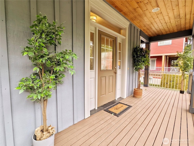 doorway to property with a porch and board and batten siding