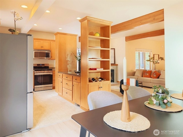 dining area featuring beamed ceiling, recessed lighting, and a fireplace with raised hearth