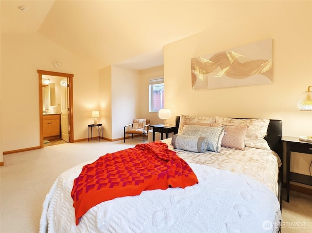 carpeted bedroom featuring ensuite bathroom, lofted ceiling, and baseboards