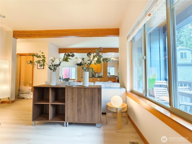 kitchen with beam ceiling, light wood-style floors, baseboards, and open shelves