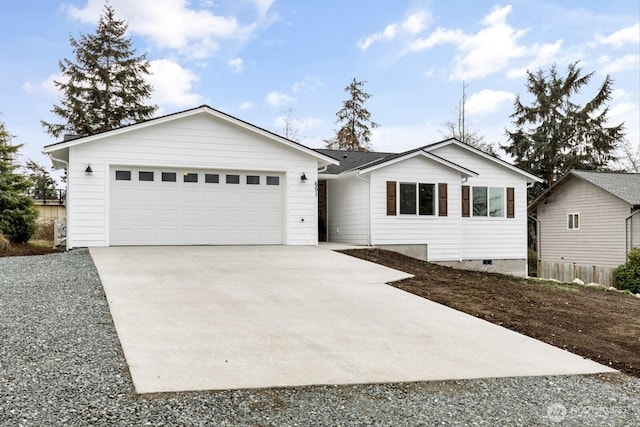 ranch-style house with driveway and an attached garage