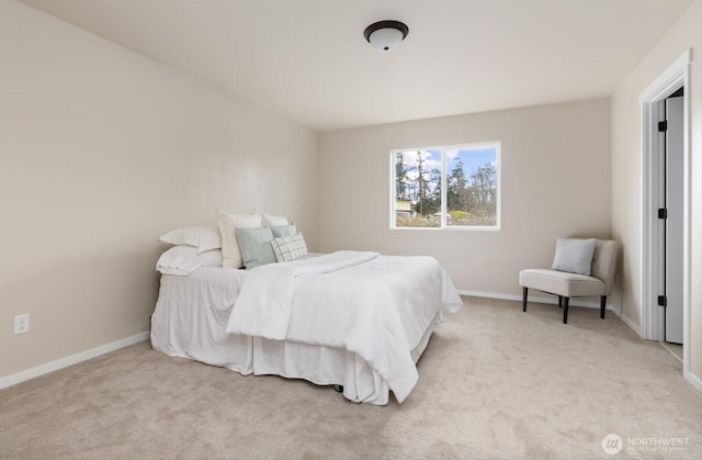 bedroom featuring light colored carpet and baseboards