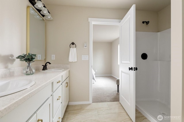 full bathroom featuring a sink, a shower, and double vanity