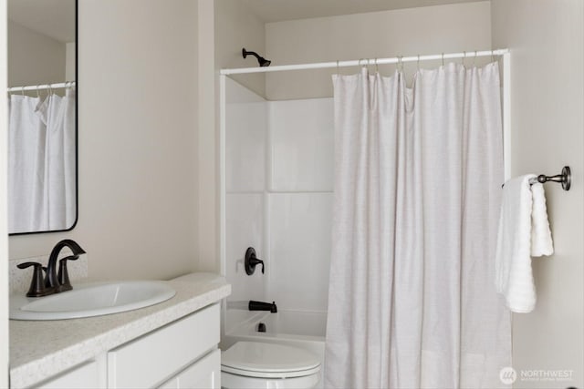 bathroom featuring shower / bath combination with curtain, toilet, and vanity