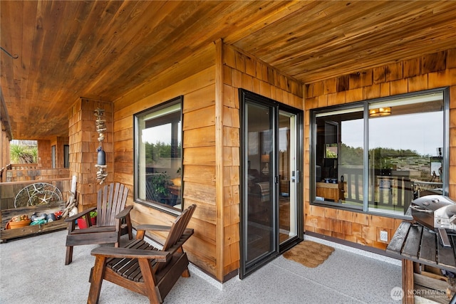 sunroom with wooden ceiling and a healthy amount of sunlight