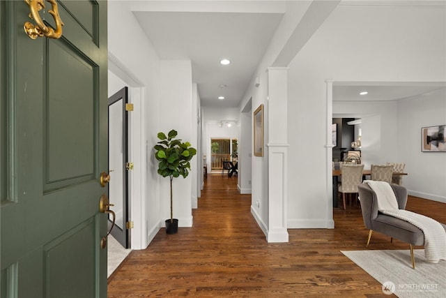 foyer featuring recessed lighting, dark wood-style flooring, and baseboards