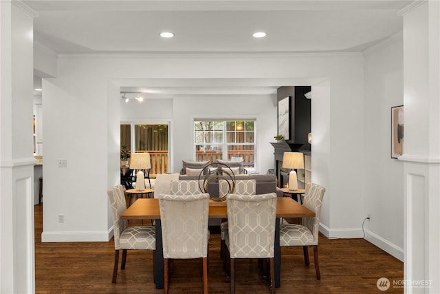 dining space featuring crown molding, recessed lighting, wood finished floors, and baseboards