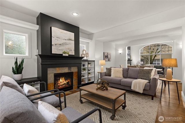 living room with wood finished floors and a fireplace