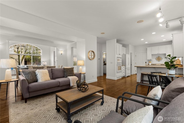 living room with recessed lighting, baseboards, and dark wood-style flooring