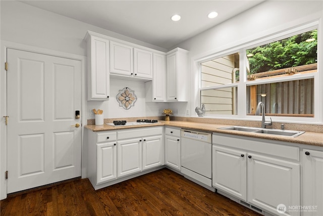 kitchen with white appliances, dark wood-style floors, recessed lighting, a sink, and white cabinetry