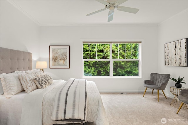 bedroom featuring crown molding, a ceiling fan, baseboards, and carpet floors