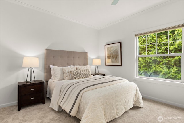 carpeted bedroom with ceiling fan, baseboards, and ornamental molding