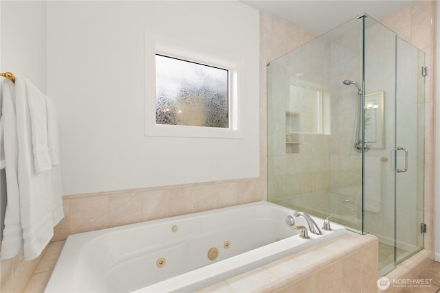 bathroom with a tub with jets and a shower stall