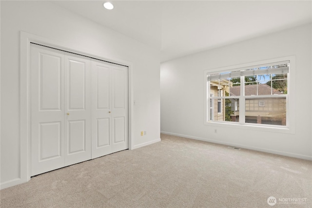 unfurnished bedroom with visible vents, baseboards, carpet floors, recessed lighting, and a closet