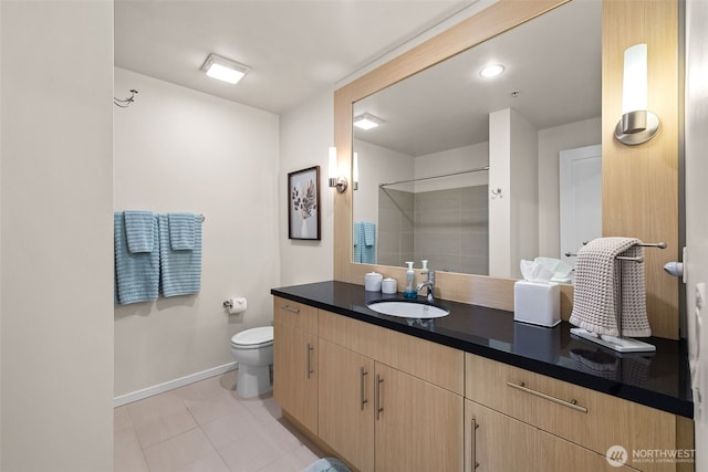 full bath with vanity, baseboards, tile patterned floors, toilet, and a shower