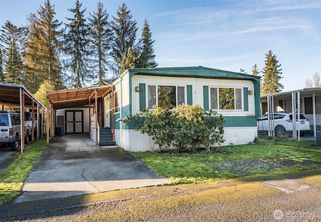 manufactured / mobile home featuring entry steps and an attached carport