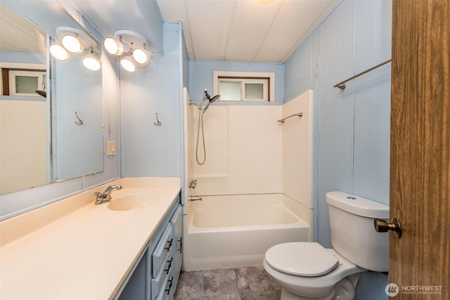 bathroom featuring shower / washtub combination, toilet, and vanity