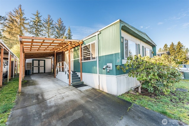 view of side of property with a carport and central air condition unit